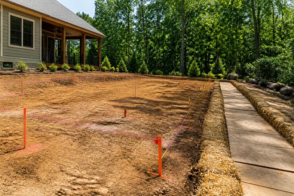 Pool layout stakeout checklist before excavation marked across a North Carolina backyard