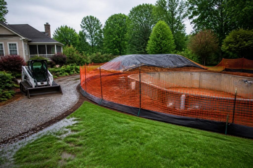 Temporary pool construction drainage runoff controls beside a secured residential excavation in North Carolina